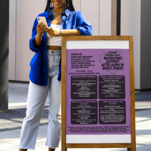 Black woman looking relieved at her phone, leaning on a marquee that showcases a photo of the Survivor Resource Guide